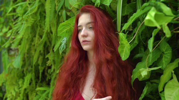 Redhead woman and green plants alt