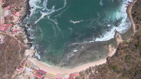 Drone flying over the island of Ixtapa located in the state of Guerrero, Mexico during a sunny day. alt