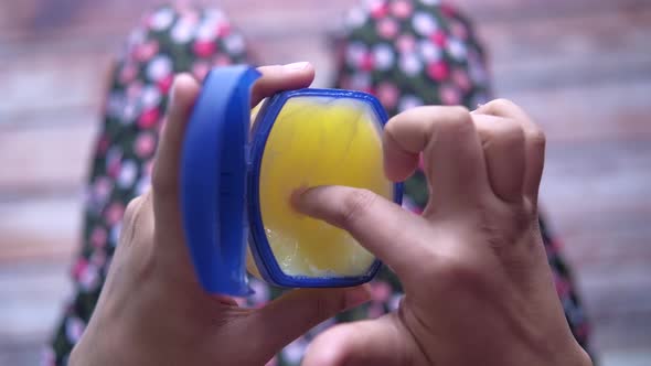 Top View of Women Hand Using Petroleum Jelly  alt