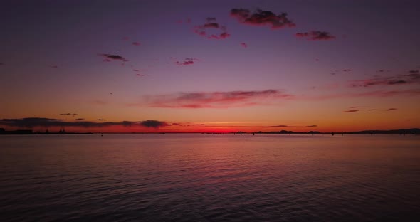 Boundless Sea with Ripple Against Shellfish Farm at Sunset alt