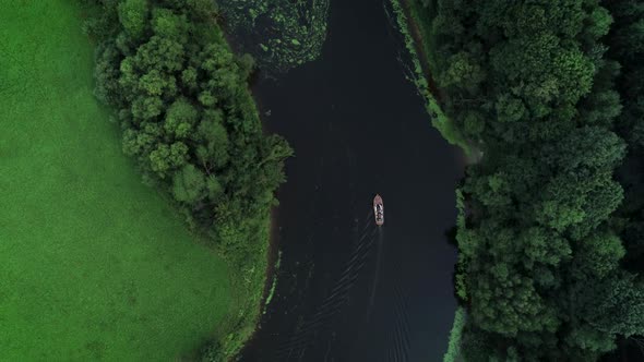 Small Wooden Boat Sailing In River