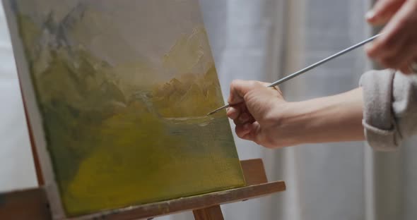 Landscape Artwork on Canvas Woman Is Painting Picture By Paintbrush and Oil Dyes Closeup View alt