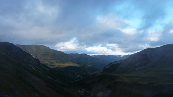 Valley of Volcanic Mountains and Rolling Rain Clouds in Kamchatka