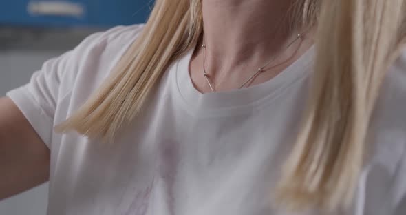 Purple Liquid Pours on a Woman's White Tshirt