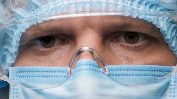 Eyes of Onfident Doctor or Healthcare Worker in Personal Protective Kit Preparing for Surgery