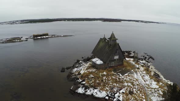Aerial view of old house on winter coast alt