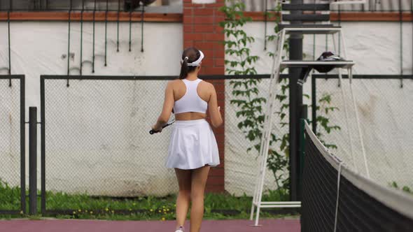 Attractive Woman Playing Tennis on Court