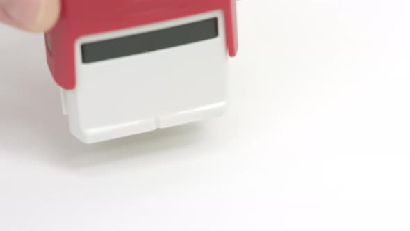 Putting Red CANCELLED Rubber Stamp on the Paper alt