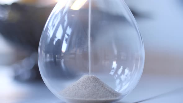 Hourglass sand falling in slow motion alt