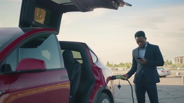 The Average Plan Portrait of Handsome African Man in Business Suit Holding alt