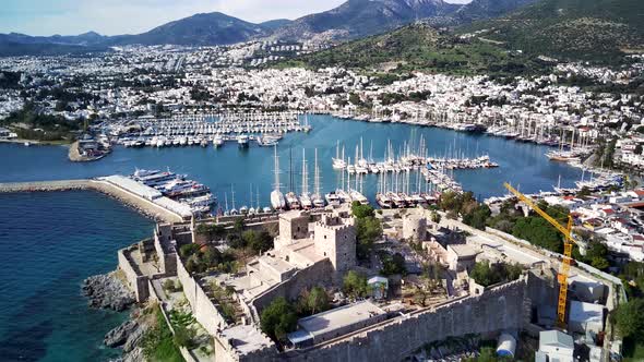 Amazing panoramic view from drone of full of yachts Bodrum harbour and ancient Kalesi castle. alt