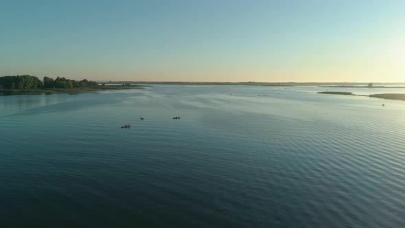 Aerial Drone Footage. Tourists Are Kayaking. Beautiful Sunrise Over River alt