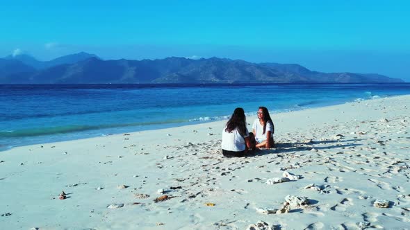 Girls best friends on beautiful sea view beach trip by blue water and white sand background of Bali  alt