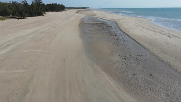 Slow moving aerial drone shot of Lee Point Beach and people walking in Northern Territory alt