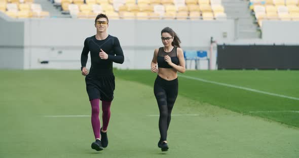 Joggers Running on Stadium