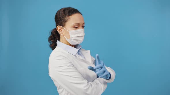 Confident Female Doctor in Protective Medical Face Mask Coming Into Shot and Looking at Camera with alt