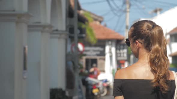 Woman Searches for Gift Shop Enjoying Atmosphere in City alt