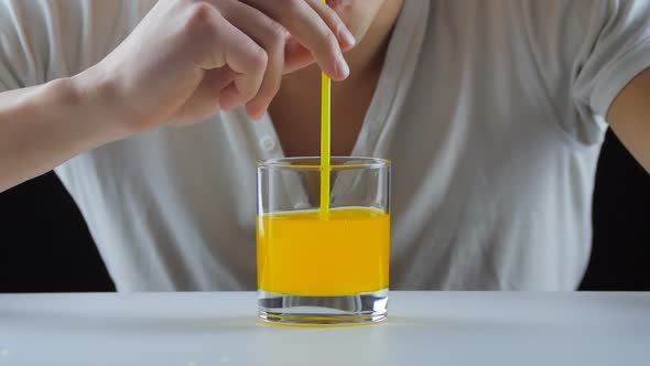 Man Drinking Orange Soda with a Straw
