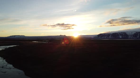 Flying Over Glacier River at Sunset with Text Space Sliding Camera alt