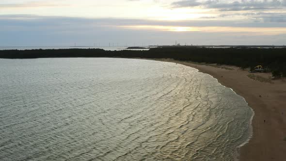 Aerial view of the Yyteri beach and calm waves, on a partly sunny evening, in Pori, Finland -  track alt