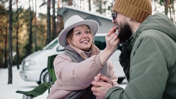Romantic Couple Eating in the Woods on Sunny Winter Day Enjoying Van Life
