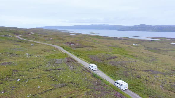 Aerial Drone View of Scotland Highlands Road Trip Driving Holiday in Mountains, with Car on Scottish alt