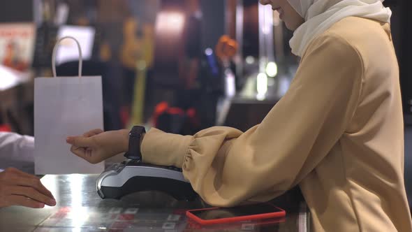 Asian Muslim Woman Using smartwatch For Payment 04