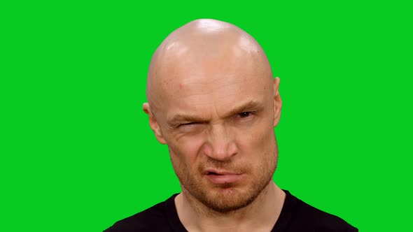  Distrustful Angry Bald Man Looking At Camera on Green Screen