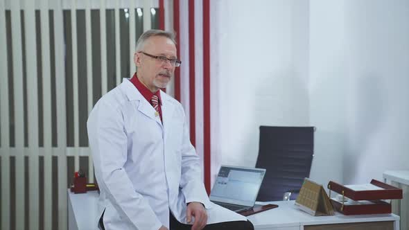 Doctor is working in his medical office alt