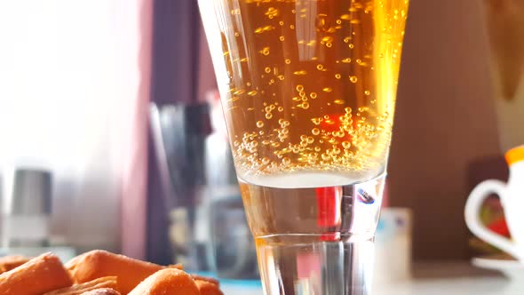 Close-up of a beer glass with bubbles rising up, 4K video