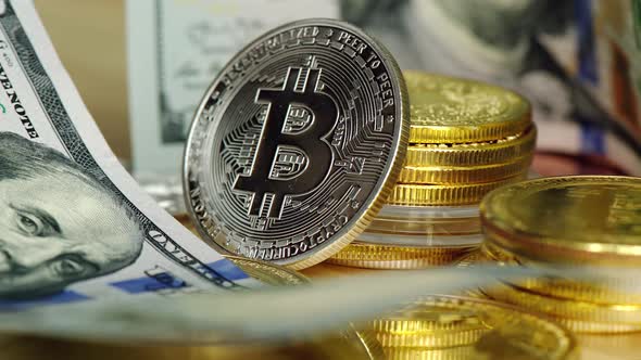 Close up crypto coins with silver bitcoin and dollars alt