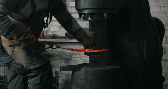 Blacksmith Makes a Decorative Redhot Forged Metal Product with Hydraulic Hammer Blacksmith's alt