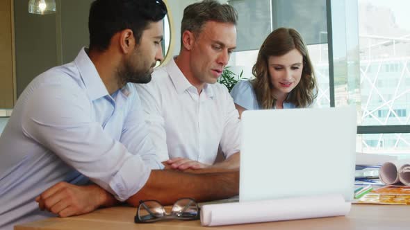 Business people working together on laptop at table in a modern office 