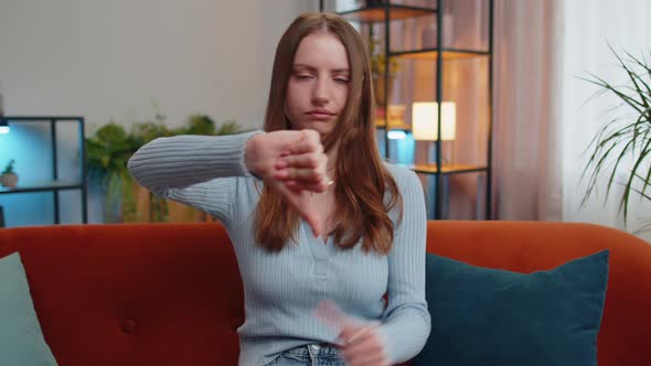 Upset Young Woman Showing Thumbs Down Dislike Bad Work Disapproval Dissatisfied Feedback at Home alt
