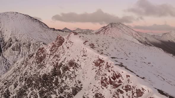 Amazing Aerial Flight Over Foggy Mountains Range Meadows and Snowcapped Peaks in Winter Time