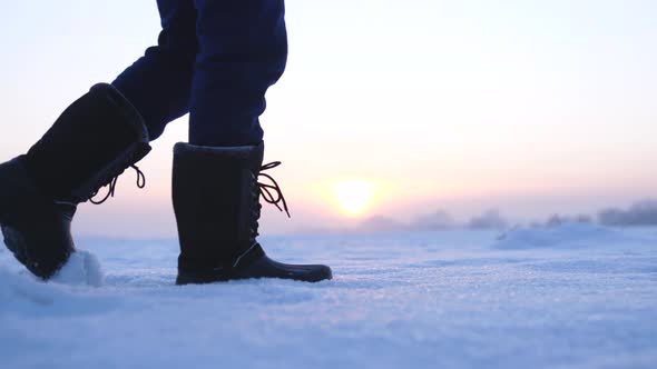 Male Feet Walking in Deep Snow