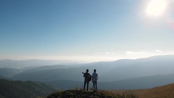 Aerial View Silhouette of Males Enjoying With Guitar on Their Mountains Vacation at Sunset