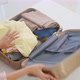 Close up hands of young woman preparing clothes and packing a suitcase. - VideoHive Item for Sale