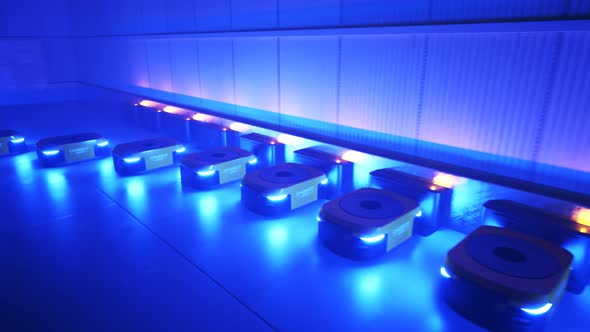 Animation with a warehouse industry autonomic robots starts work after charging alt