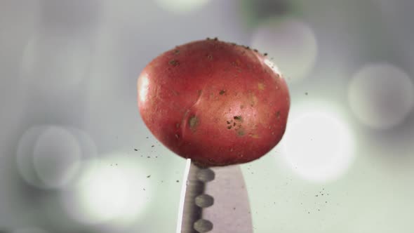 Fresh Red Potato Falling Down with Soil on Knife Stuck alt