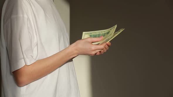 Successful woman checking amount of cash money. Close Up businesswoman hands holding one hundred 