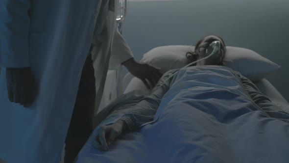 Doctor checking a patient lying in bed at the hospital