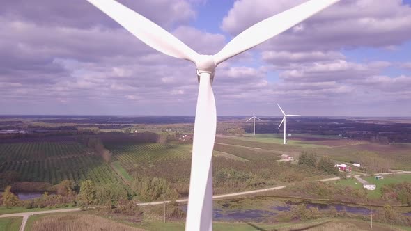 Aerial view of wind turbine creating green and renewable energy.  Camera view is descending in eleva alt