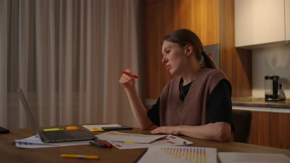 A Side View of a Woman Studying Remotely From Home Watching a Boring Lecture After a Hard Day alt