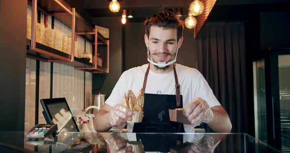 Handsome Male Bartender Handing Desserts for Tea and Coffee Serving Concept alt