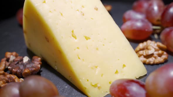 Assorted Cheeses with Nuts and Dried Fruits on the Table. Rotating Video alt