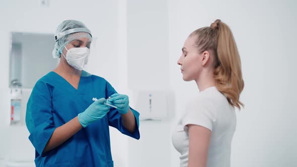 Young Female is Vaccinated Against the New Coronavirus Covid19 in a Modern Clinic the Formation of alt