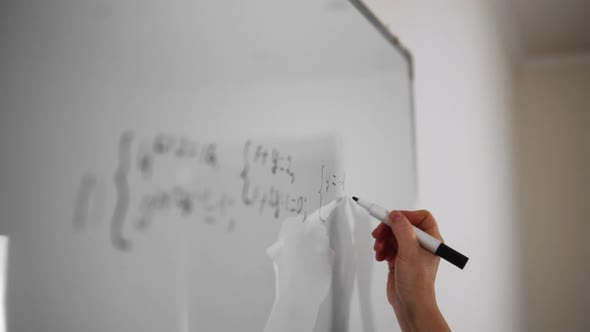 Boy Student Writing Math Equation on Whiteboard