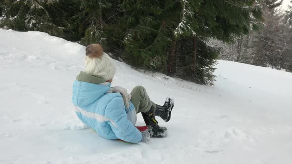Child Speeding Down Snowy Slope alt