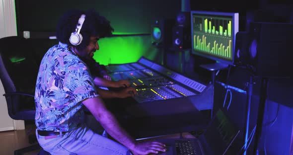 Musician and sound engineer - People mixing new album inside boutique recording studio alt